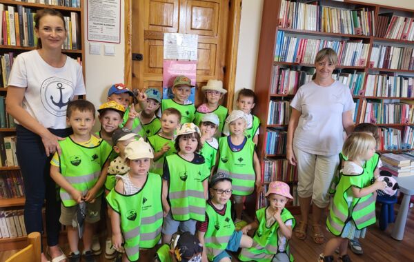 Bibliotekarka oraz dzieci pozujące do zdjęcia