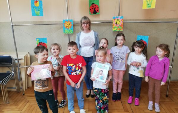 Bibliotekarz oraz dzieci biorące udział w zajęciach